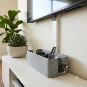 A tidy cable box tv cable management hiding power strips and plugs.